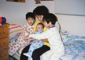 David Lee as a young chid with his family reading.